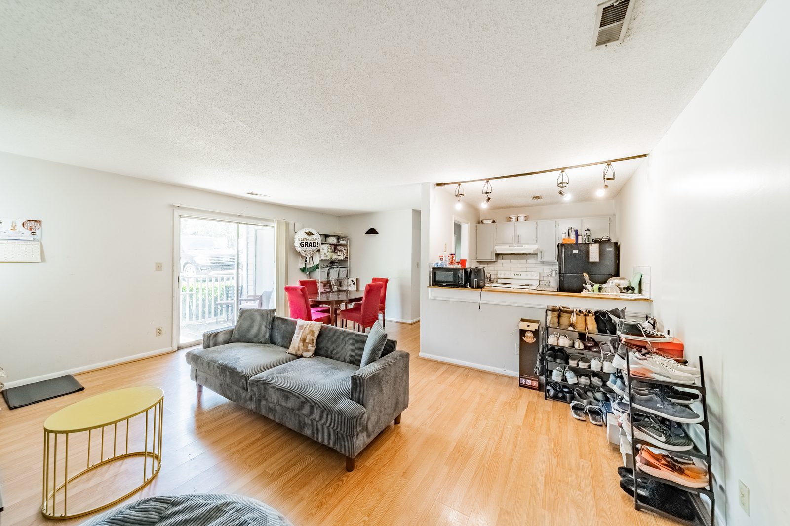 Open-concept kitchen and living room in a shared student apartment at University Terrace near UNC Charlotte
