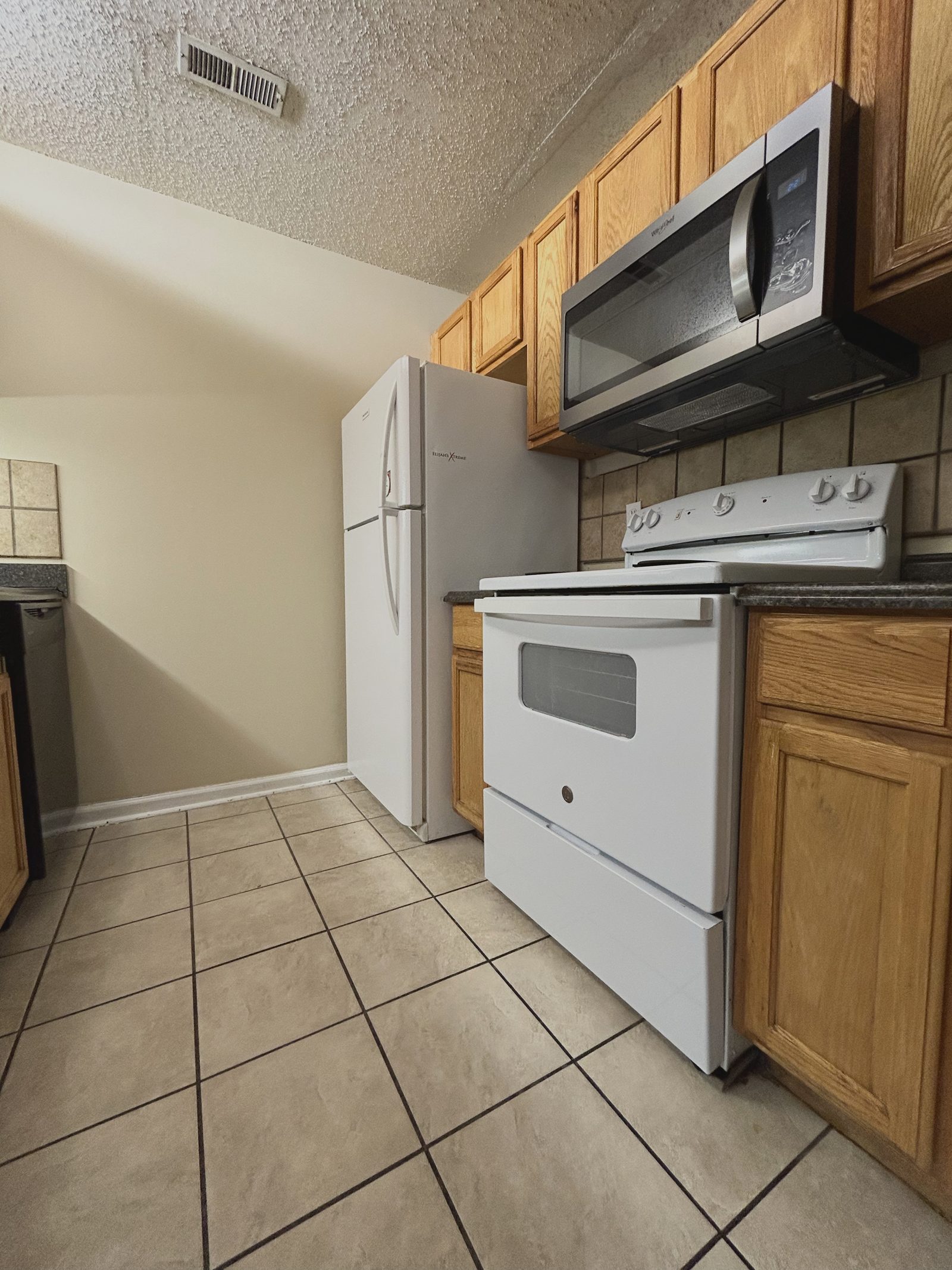 Narrow galley kitchen with no seating in a student rental near UNC Charlotte